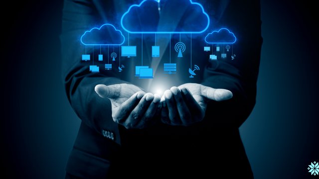Hand holding a glowing cloud connected to devices