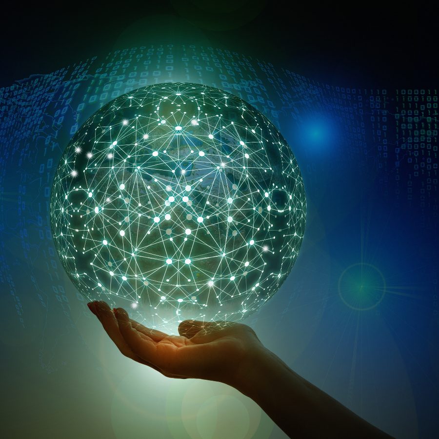 Hand holding a glowing network sphere, representing Iskratek's data-driven approach
